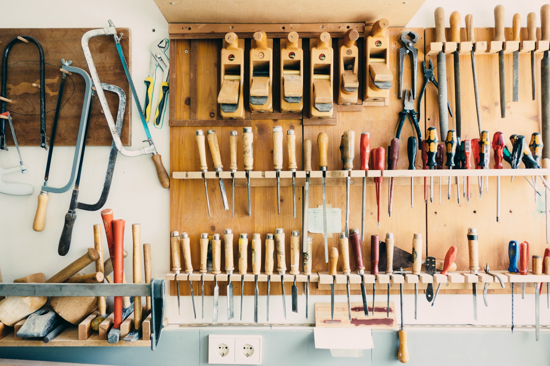 Organized tool wall with shadow-outlined tool storage