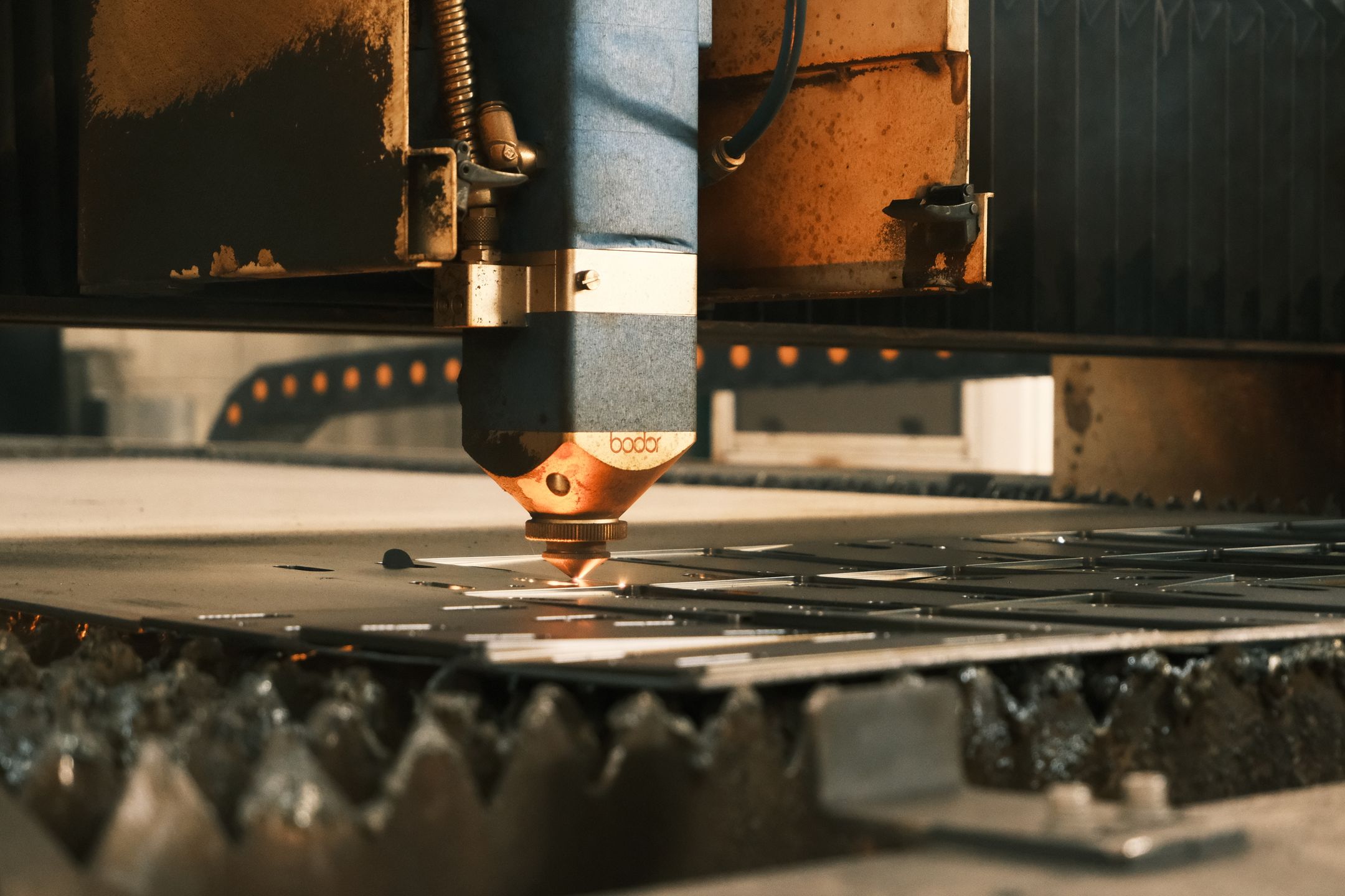 Sheet material being cut in a manufacturing process