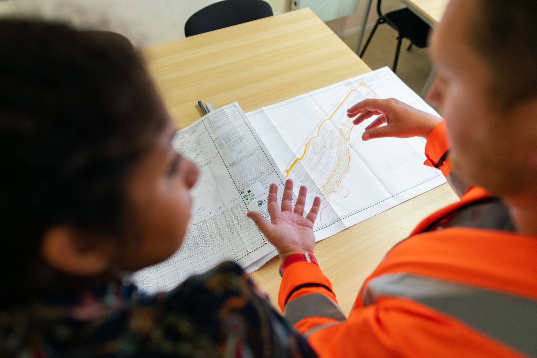 Instructor explaining a quality standard to manufacturing trainees