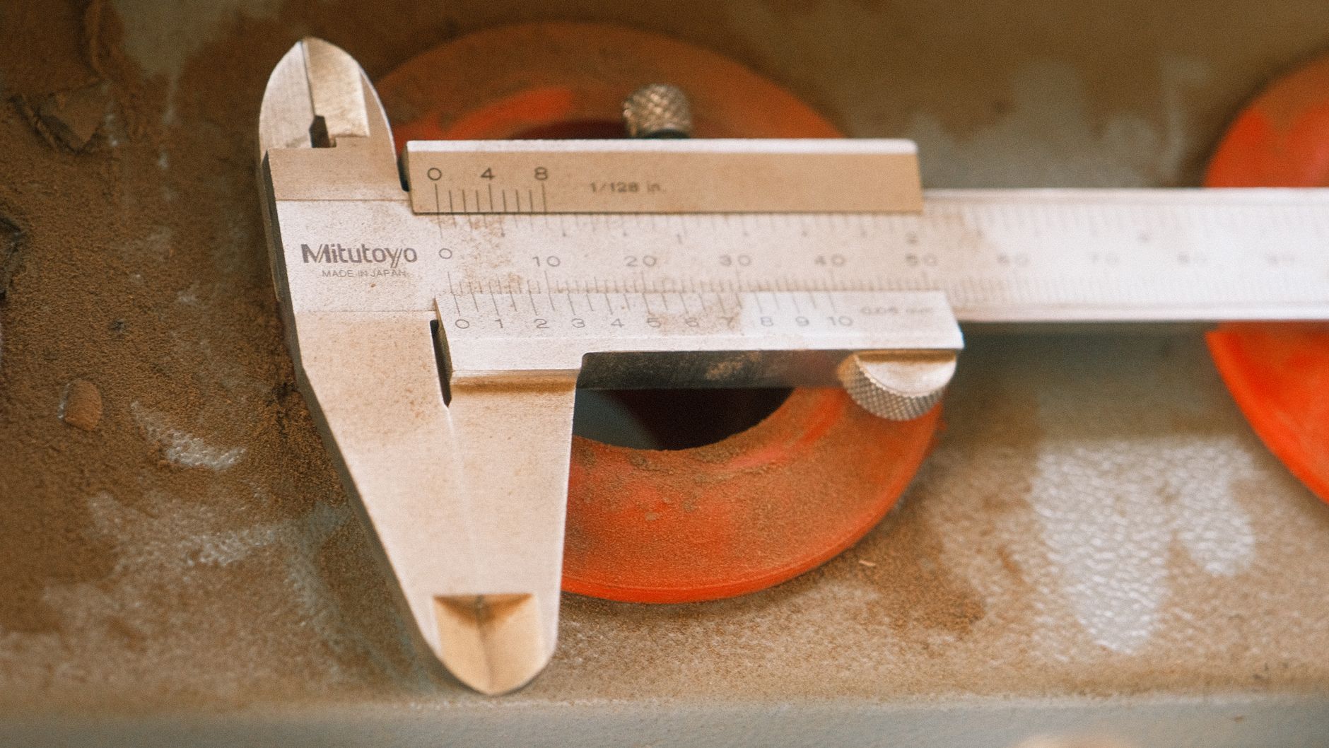Machinist measuring a part with a height gauge