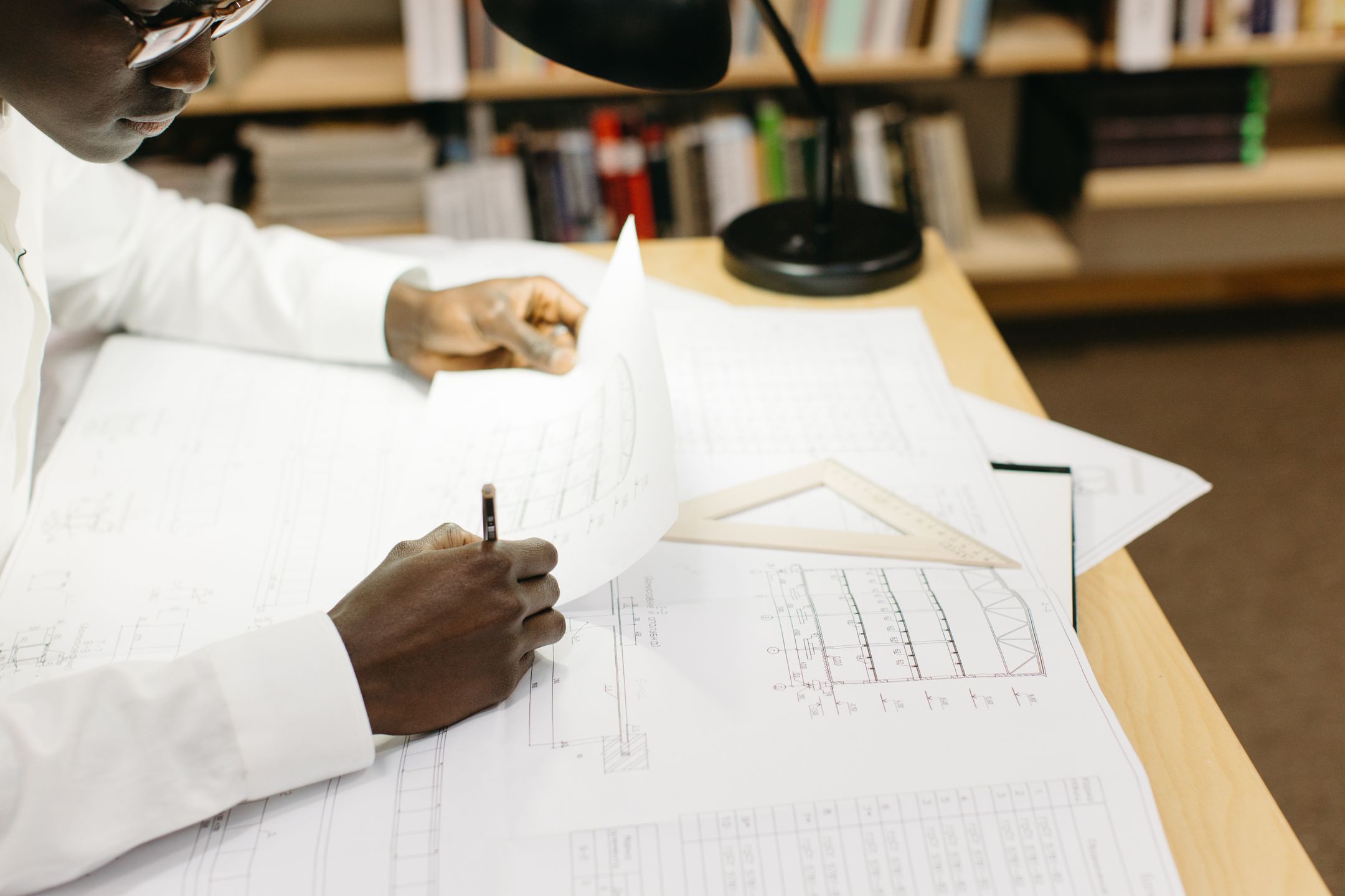 Technician reading an engineering drawing on the shop floor