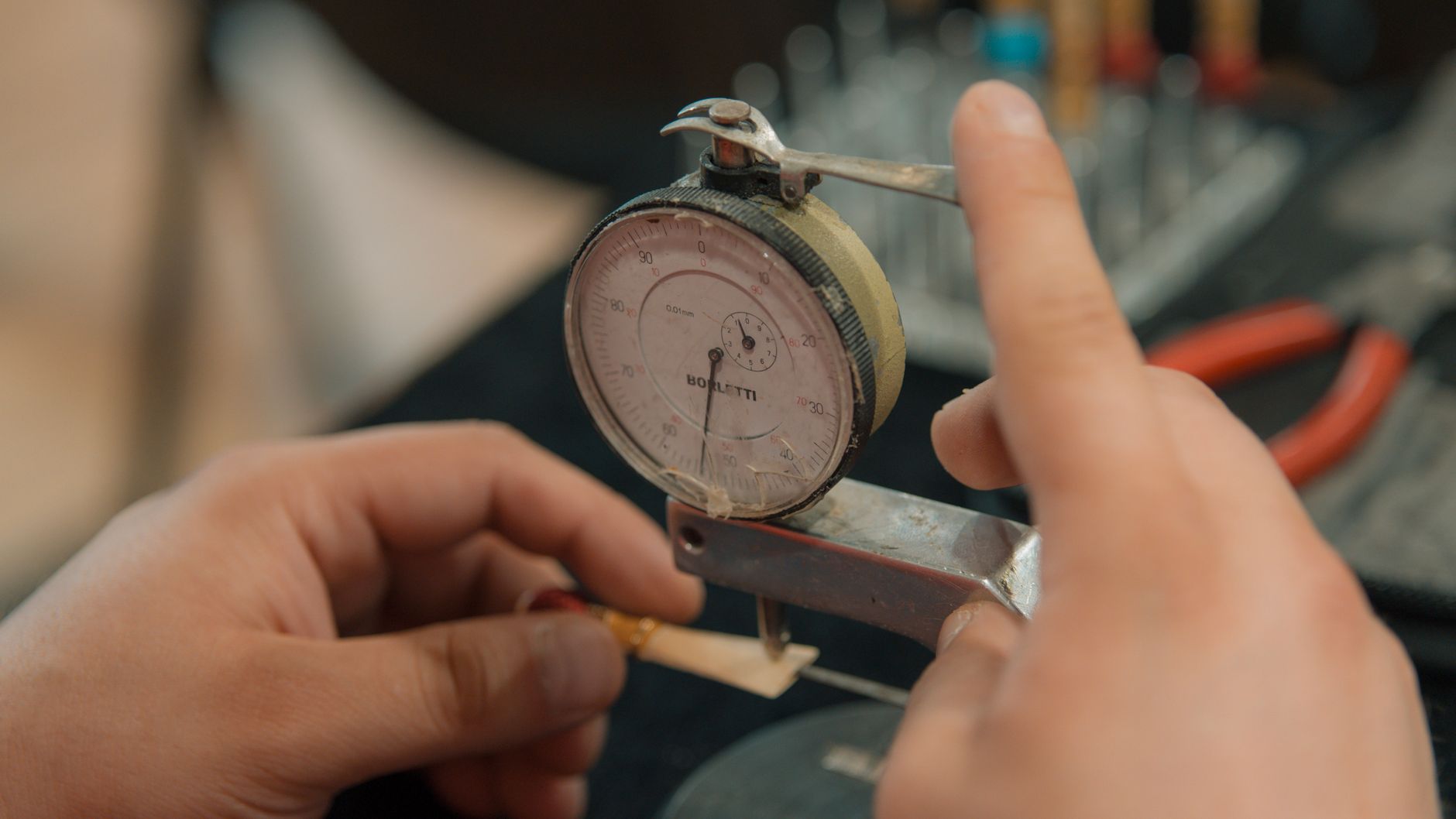 Technician inspecting a part against tolerance specifications