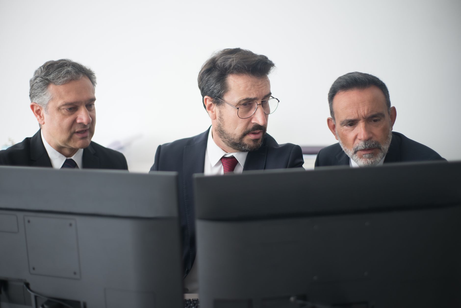 Maintenance manager reviewing an asset history report on a screen