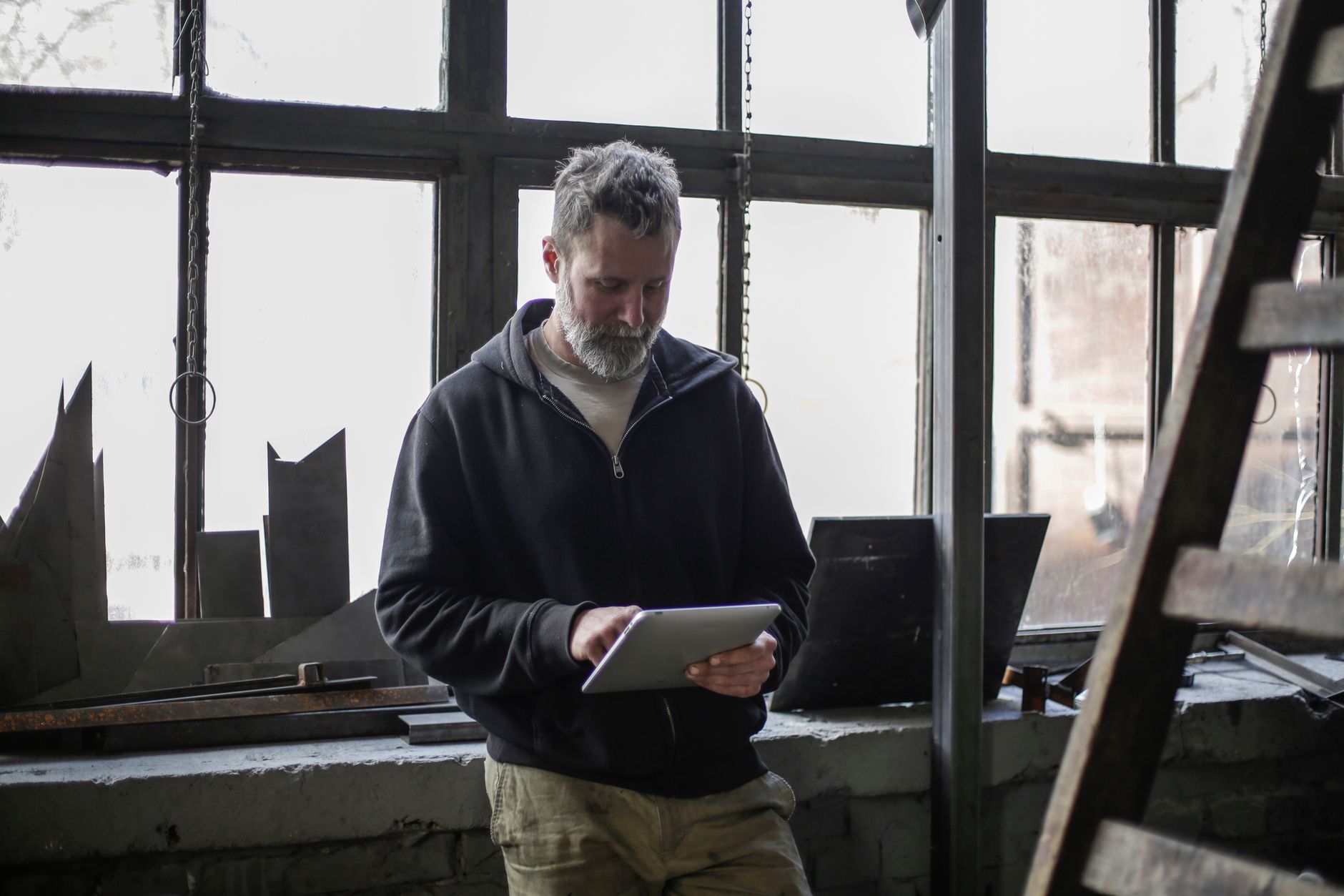 Maintenance technician updating a work order on a tablet
