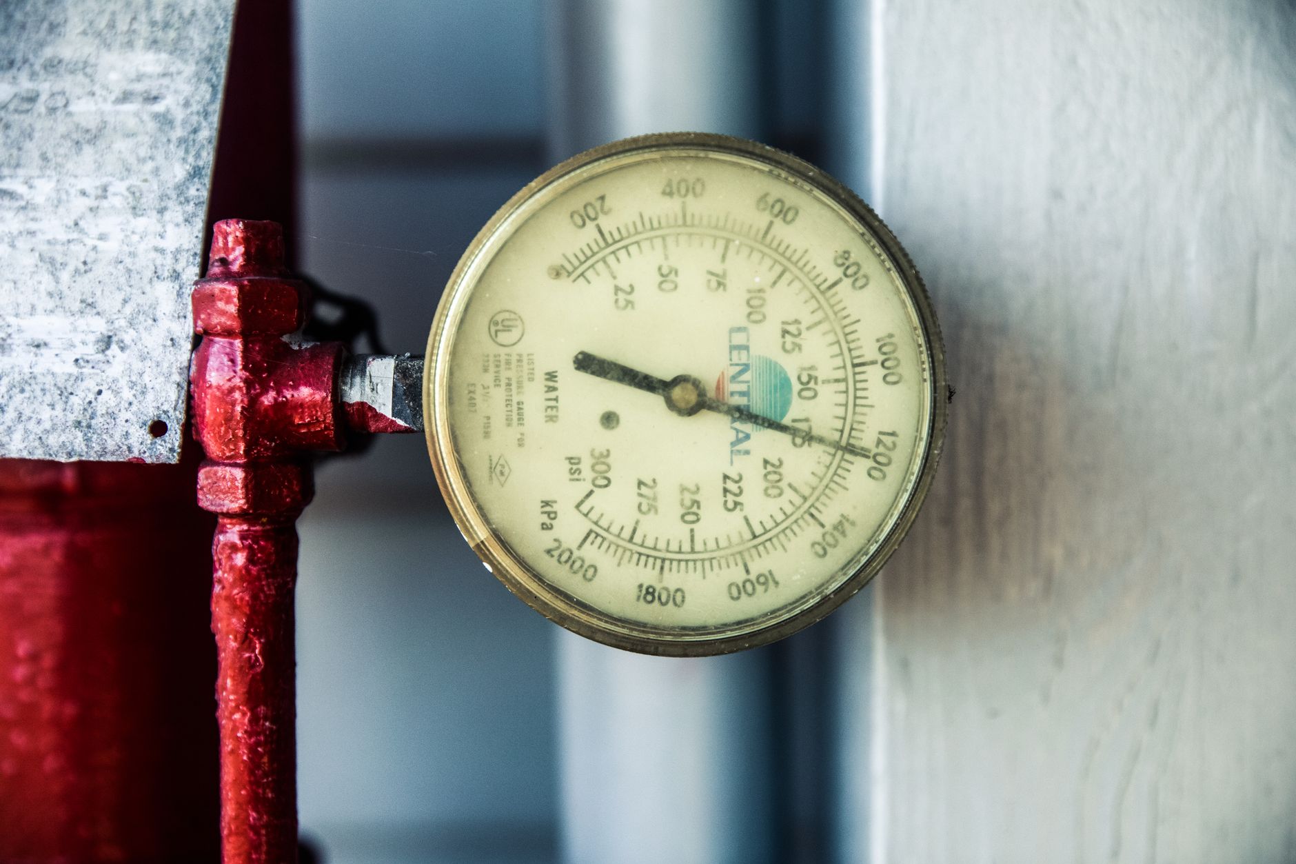 Engineer monitoring a compressed air system pressure gauge