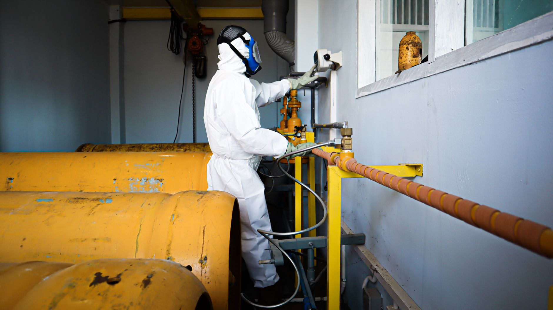 Technician testing atmospheric conditions before entry