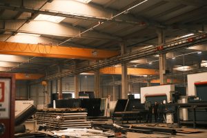 Overhead crane lifting a steel load in a factory