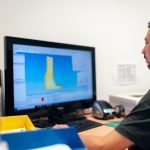 Engineer viewing a product design on a computer screen