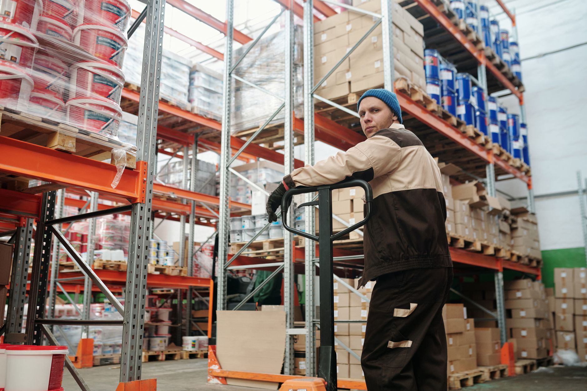 Worker transporting materials by forklift across a facility