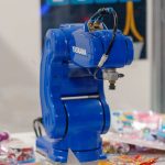Robotic gripper holding a manufactured part