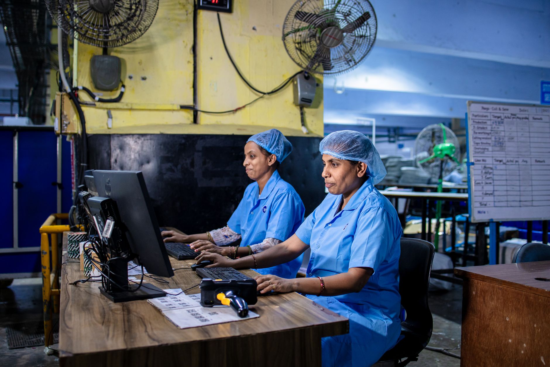 Safety manager assessing a workstation for ergonomic risk