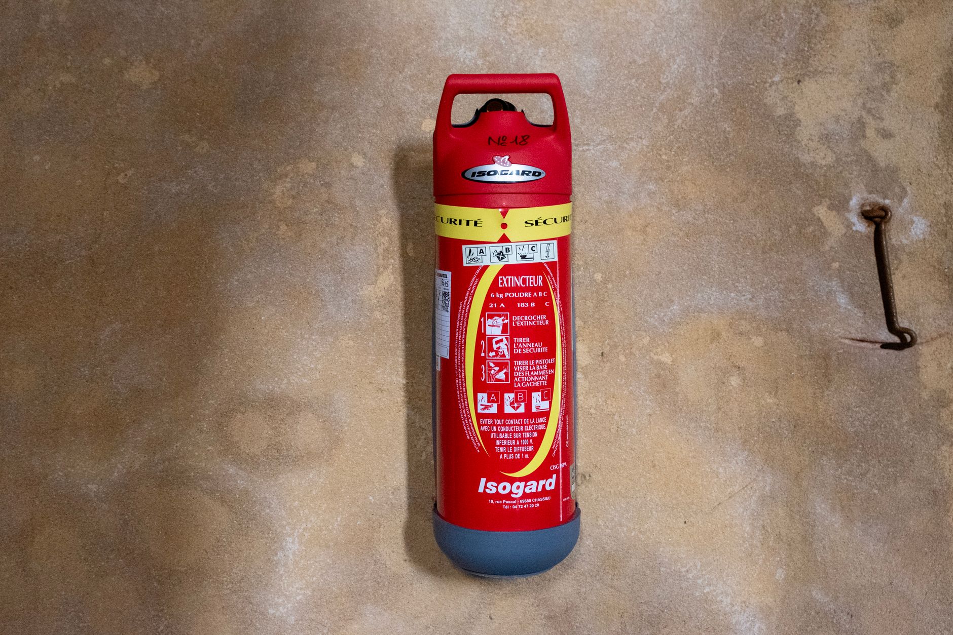 Fire extinguisher mounted on a wall in an industrial facility