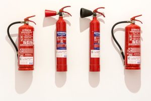 Close-up of a red fire extinguisher canister