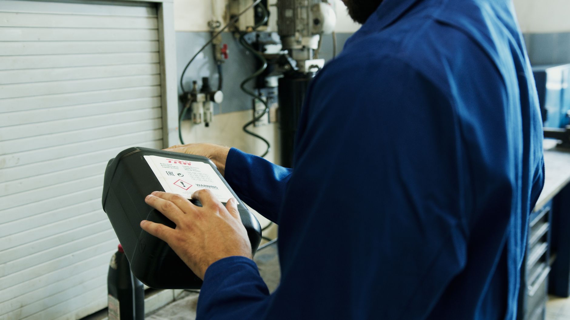 Technician inspecting a fire extinguisher inspection tag