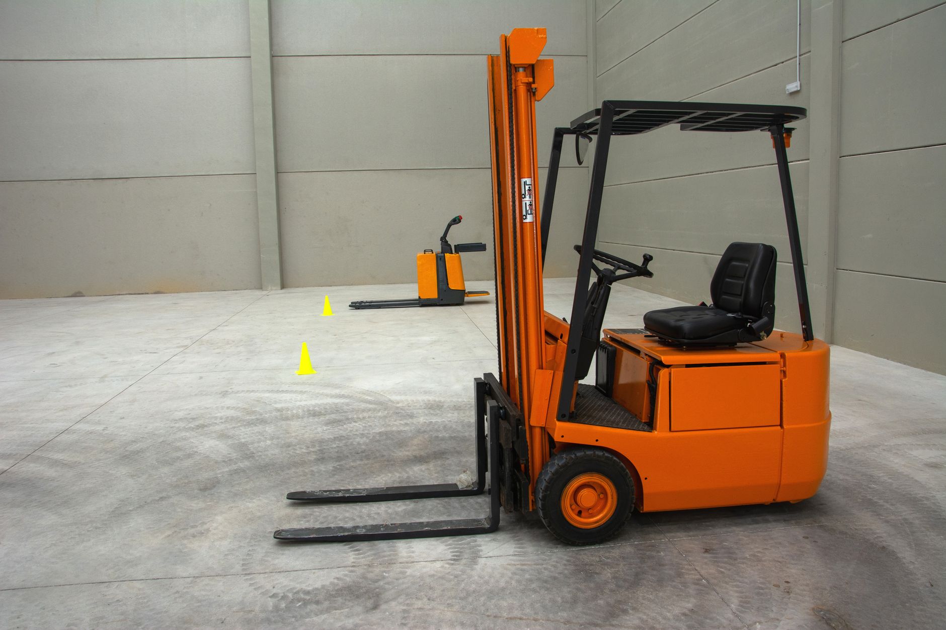 Training instructor demonstrating proper forklift operation