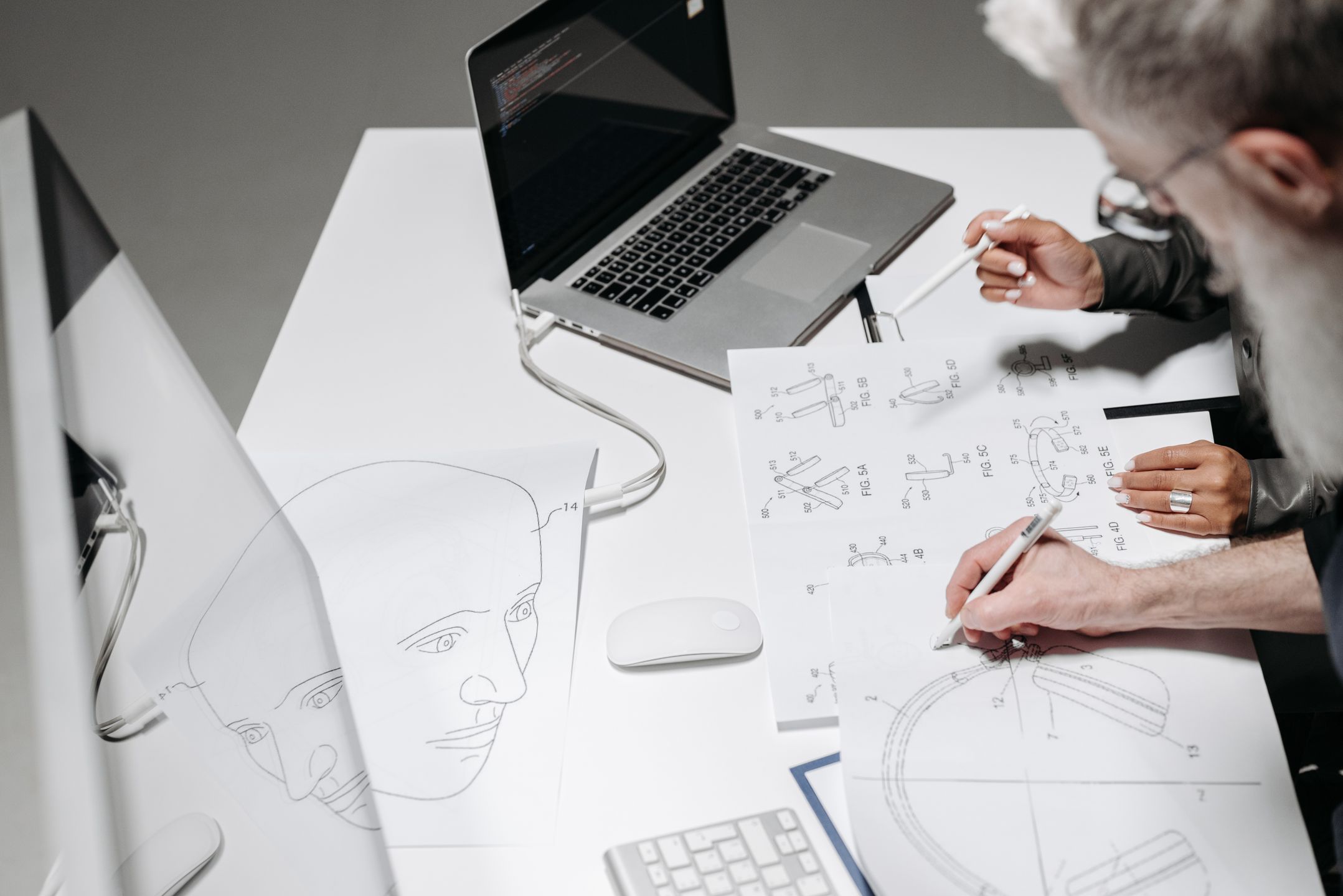 Team working on detailed technical drawings at a workspace