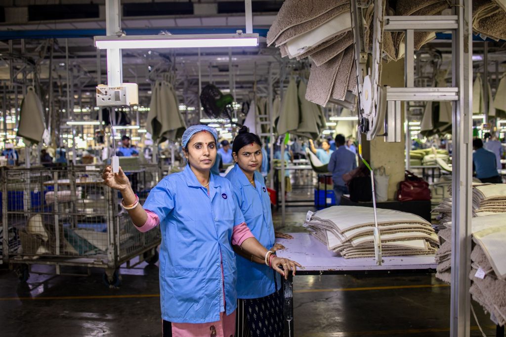 Wide view of a factory floor with workers at stations