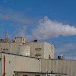 Factory exterior with emissions monitoring equipment