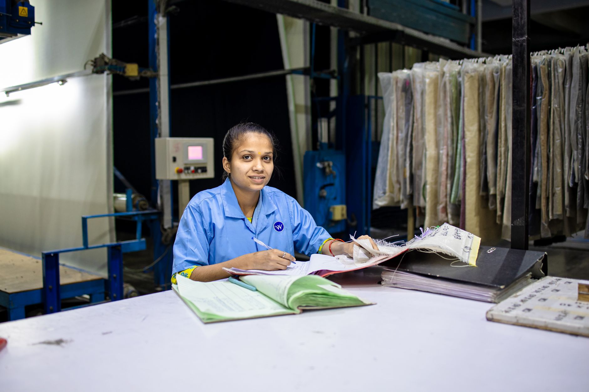 Auditor reviewing supplier documentation in a manufacturing facility