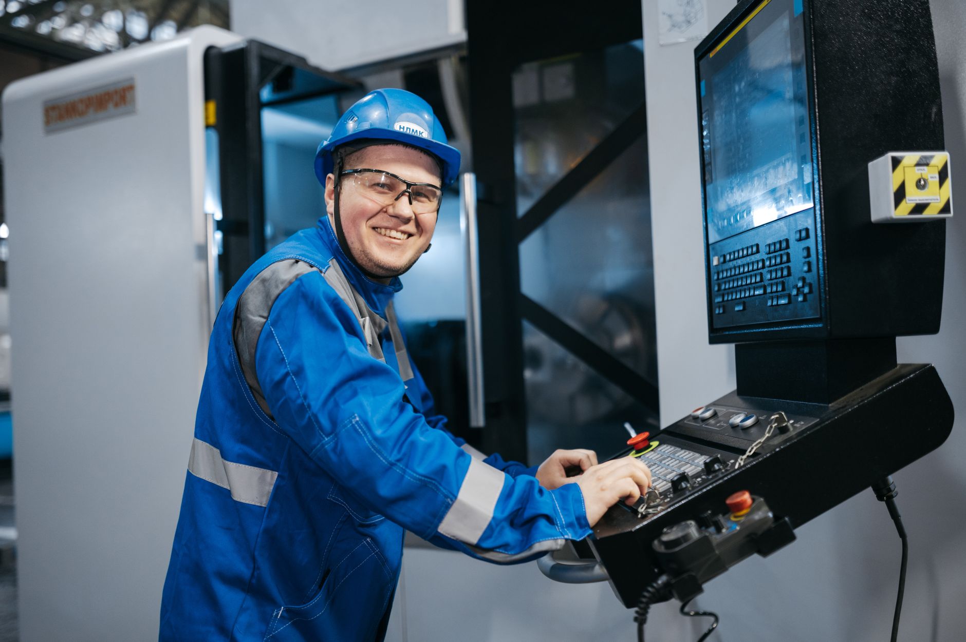 Technician troubleshooting a PLC controller on the plant floor