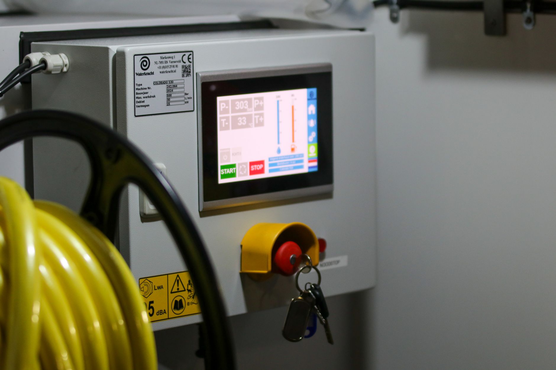 Worker pulling an andon cord to stop a production line