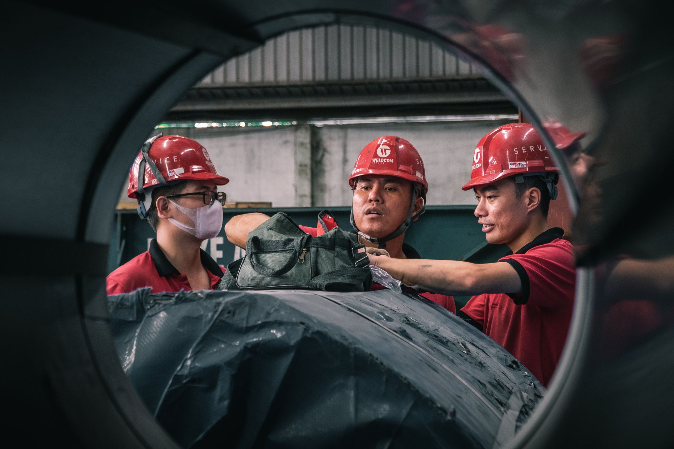 Team collaborating around equipment during a hands-on session