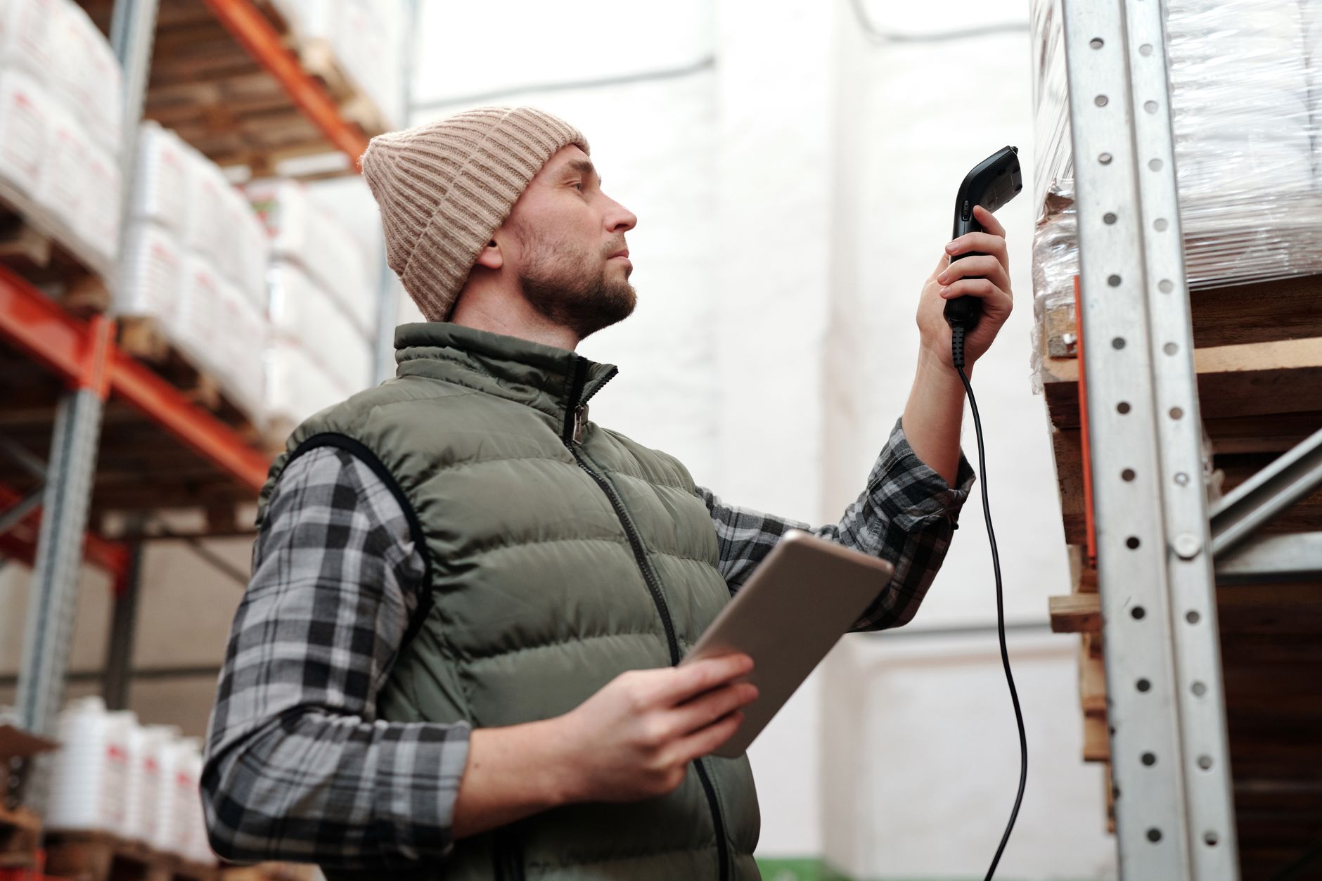 Worker scanning a kanban card for material replenishment