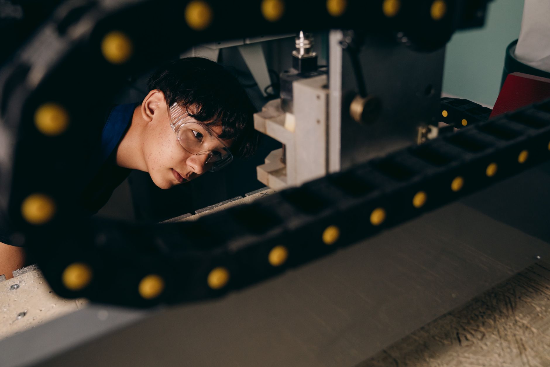Technician inspecting a machine guard interlock mechanism