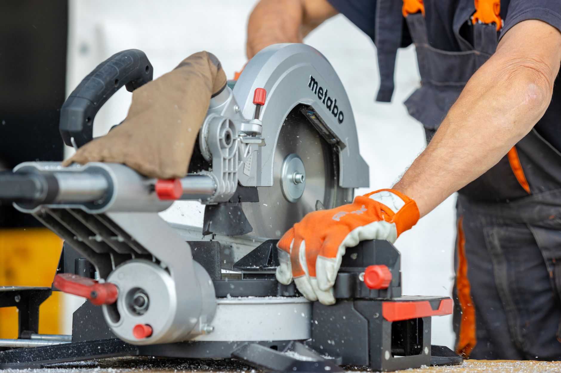 Worker operating a properly guarded power saw