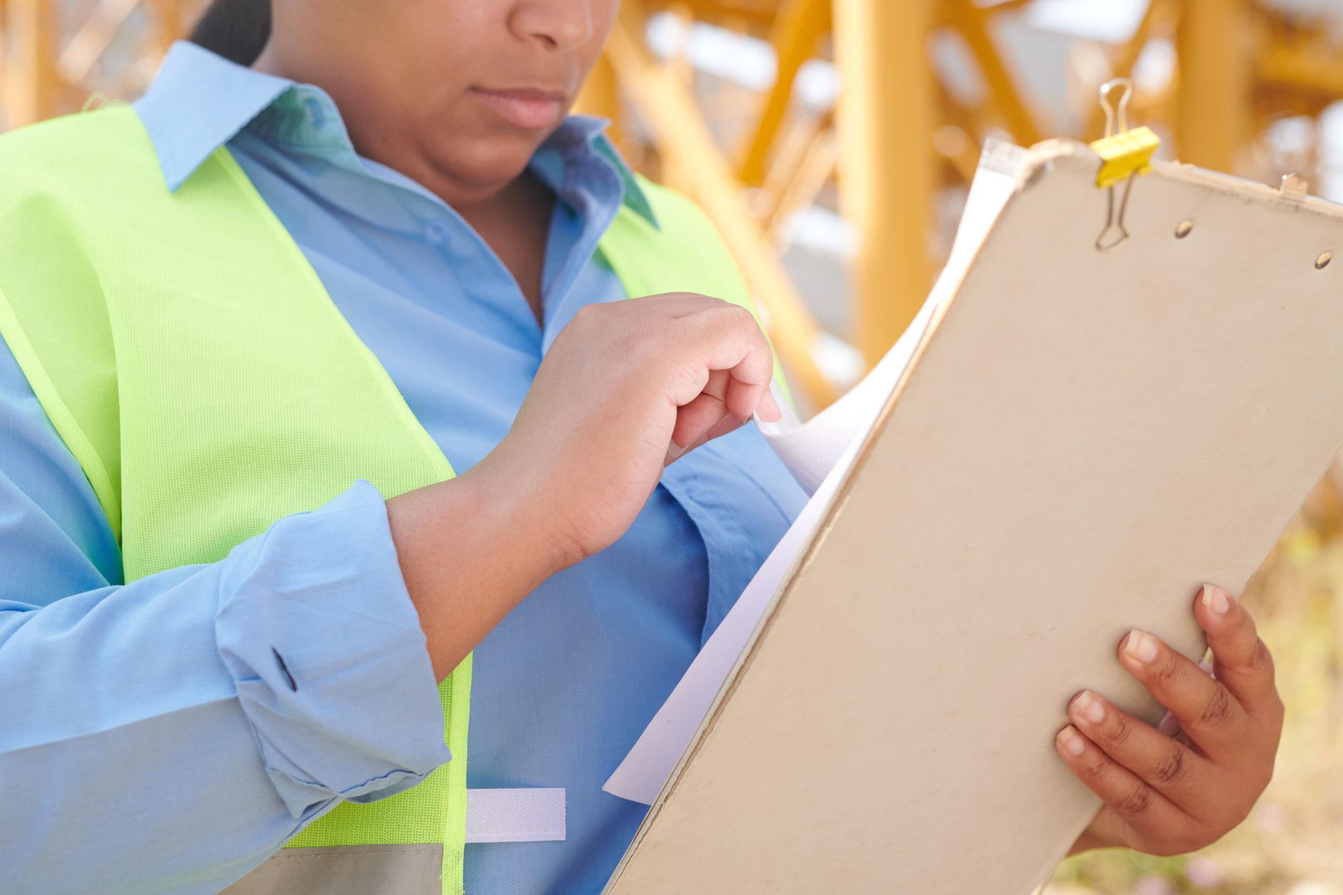 Engineer reviewing a job plan document inside an industrial facility