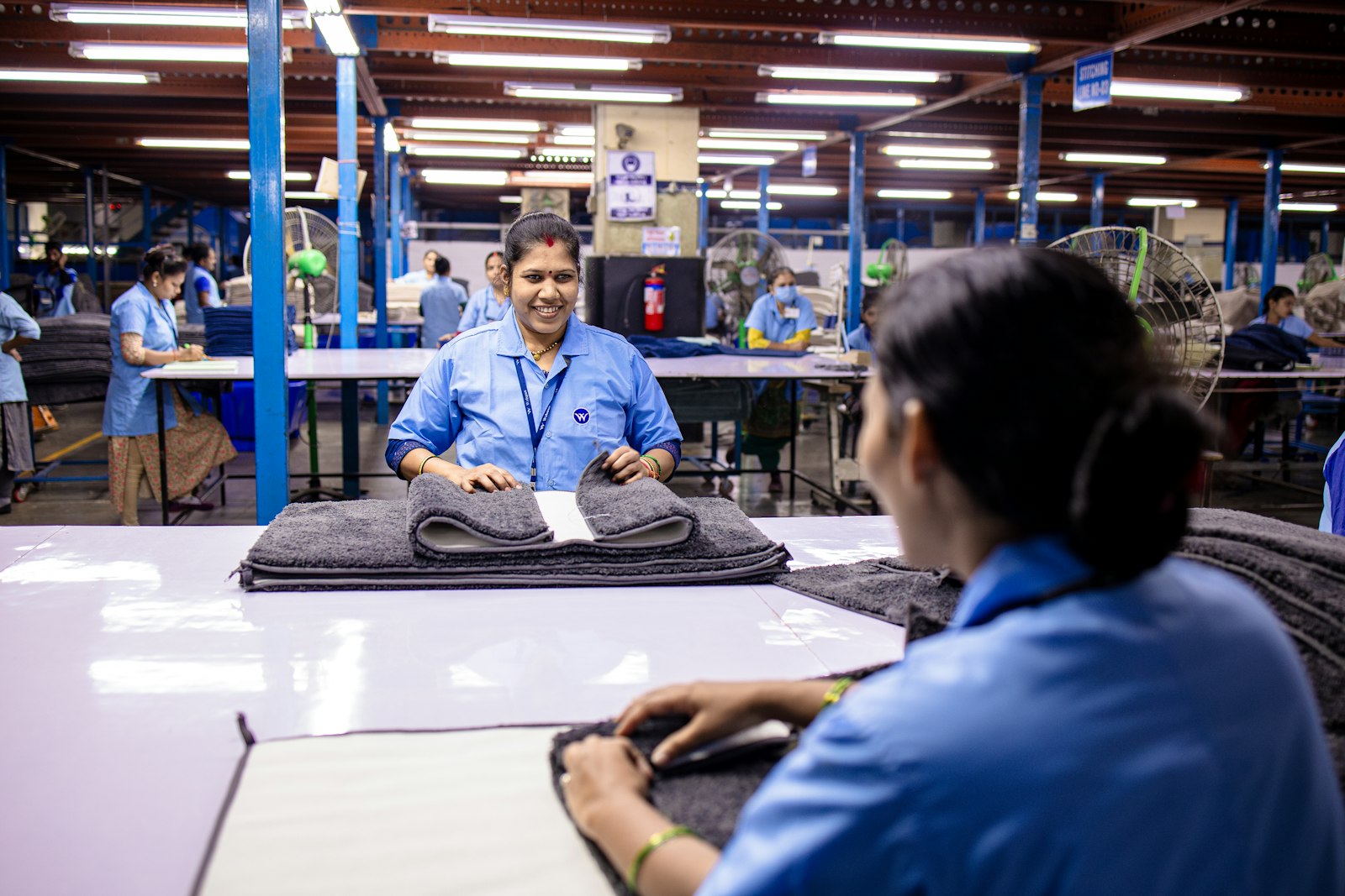 Production floor staff conferring over a work order