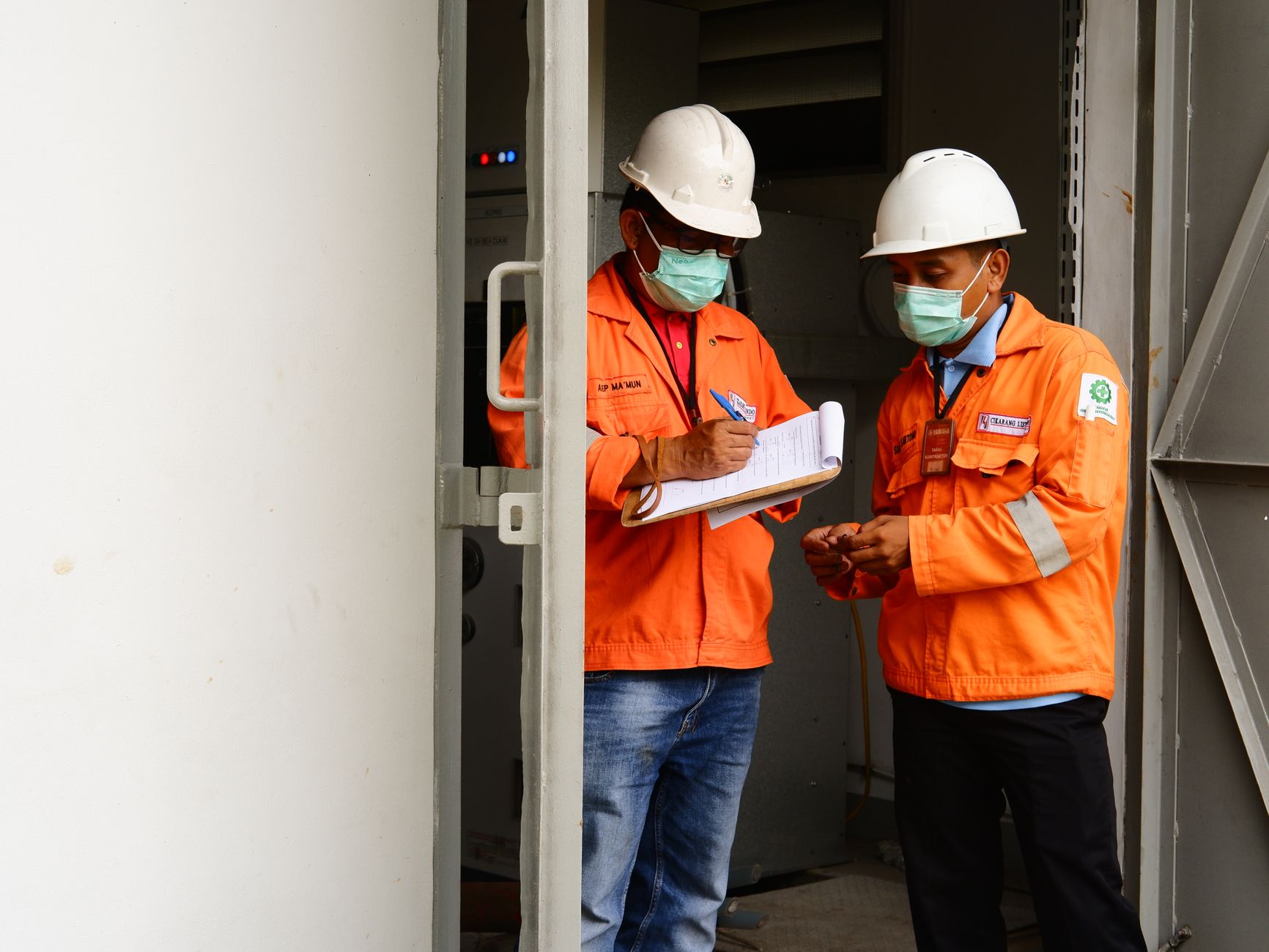 Maintenance team reviewing equipment criticality documentation together