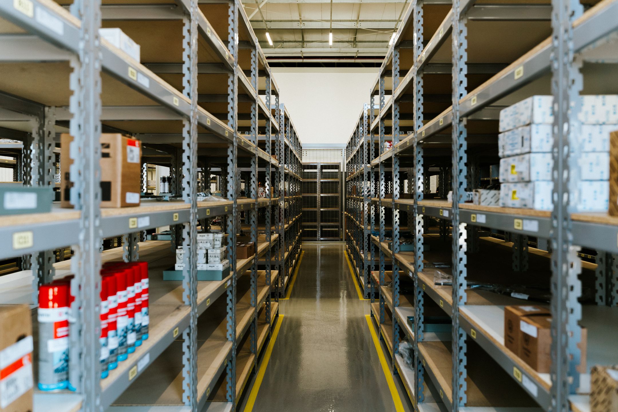 Wide view of an organized industrial warehouse with metal shelving