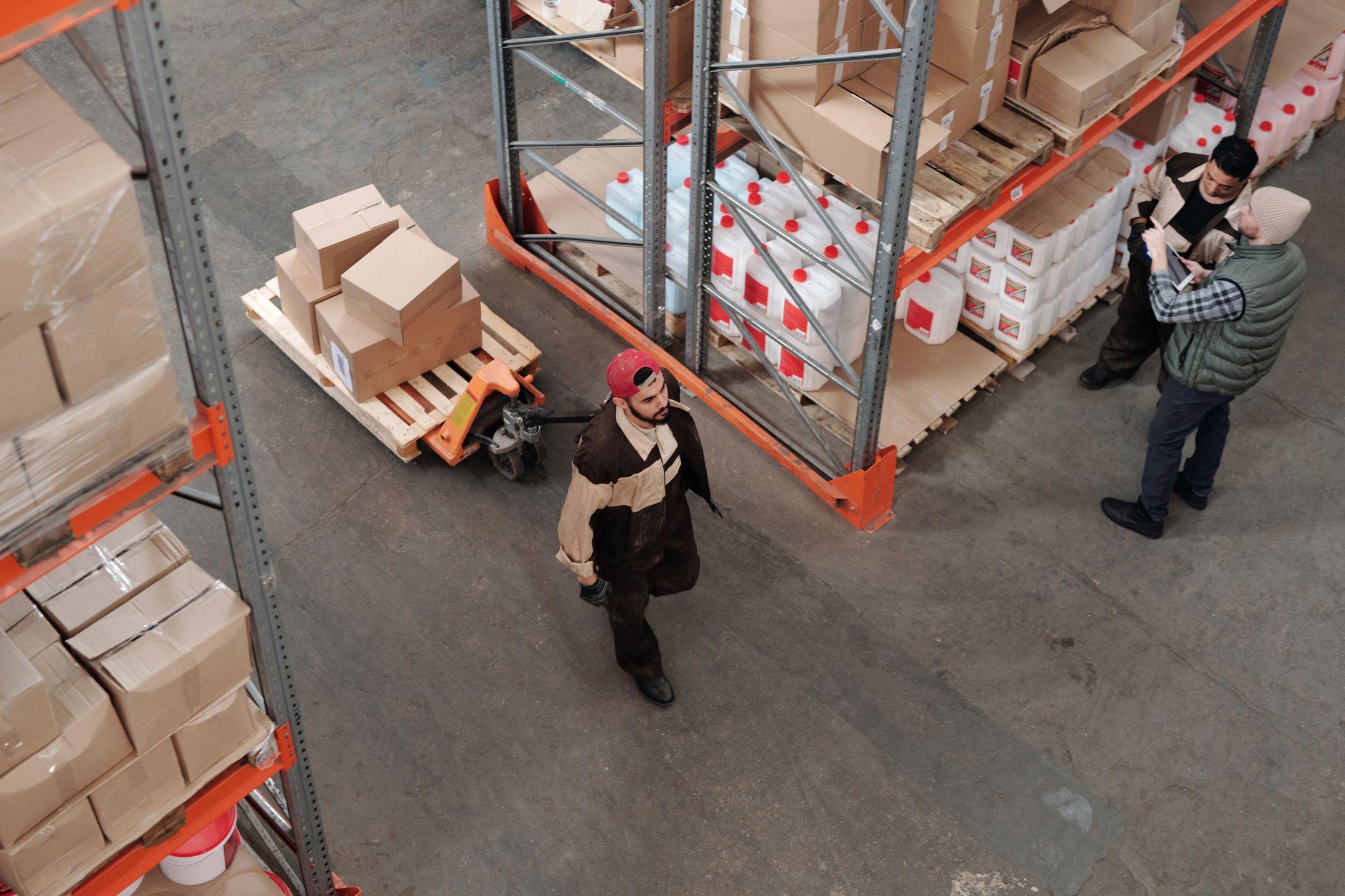 Team working in an industrial warehouse organizing inventory