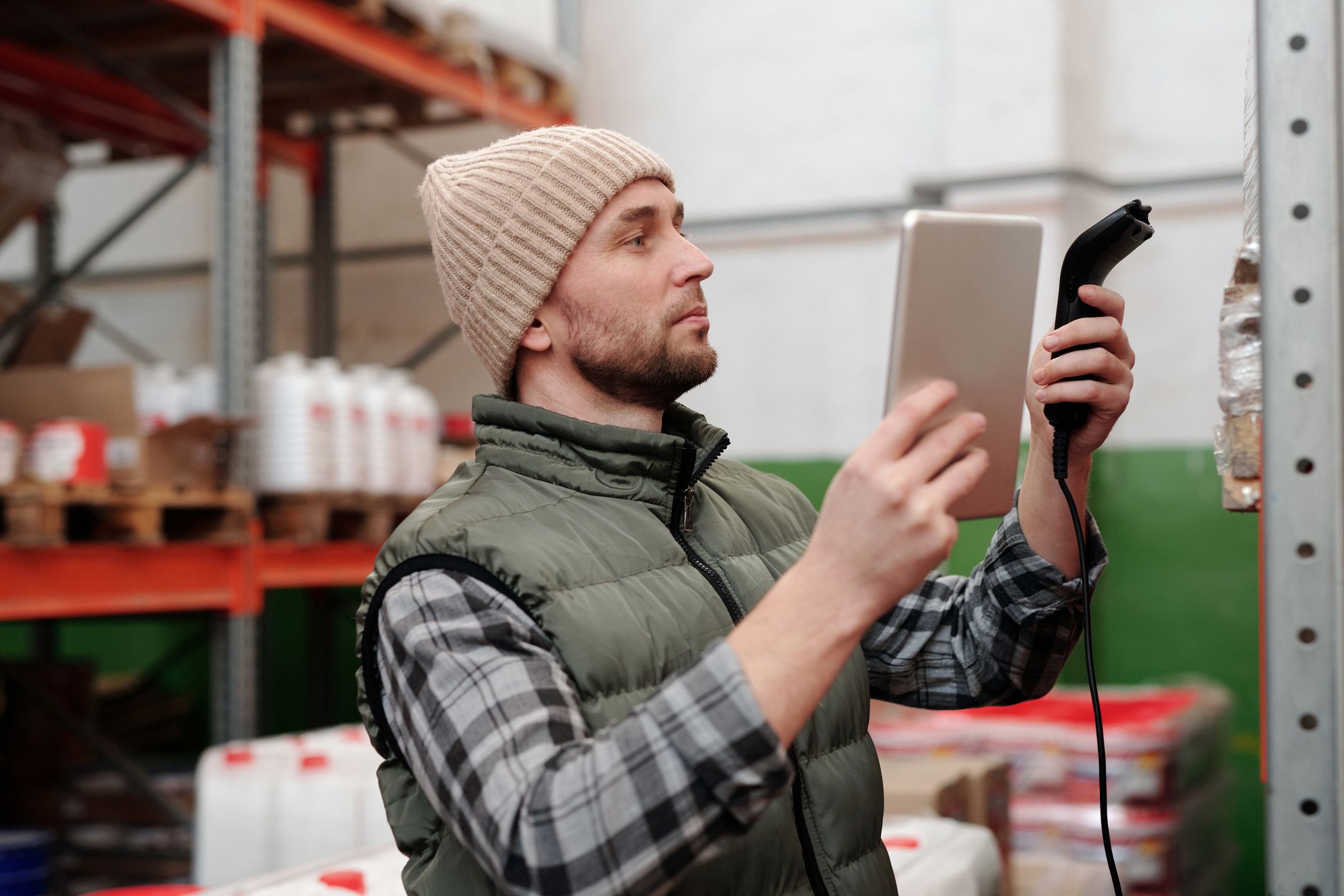 Worker using a scanner for inventory control in a warehouse