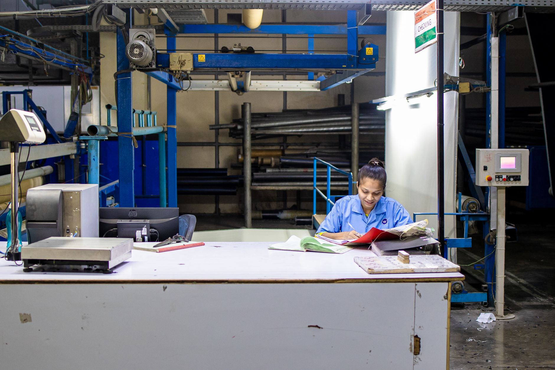 Auditor reviewing process documentation at a facility
