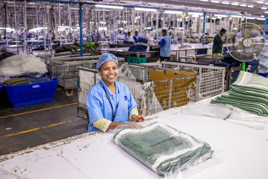 Energetic factory scene with a smiling worker