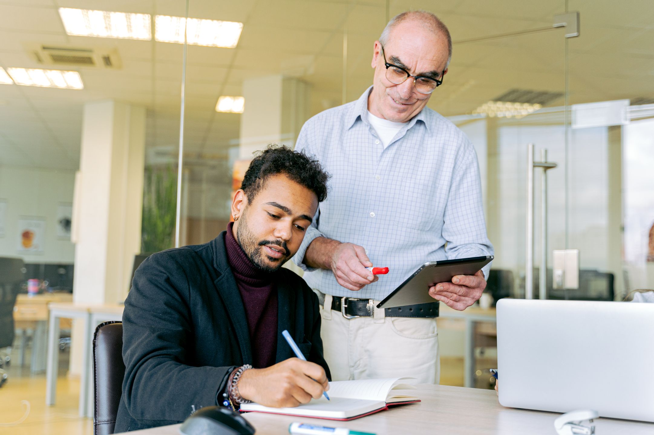 Manager mentoring a new supervisor in a one-on-one session