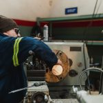 Machinist operating a CNC machine