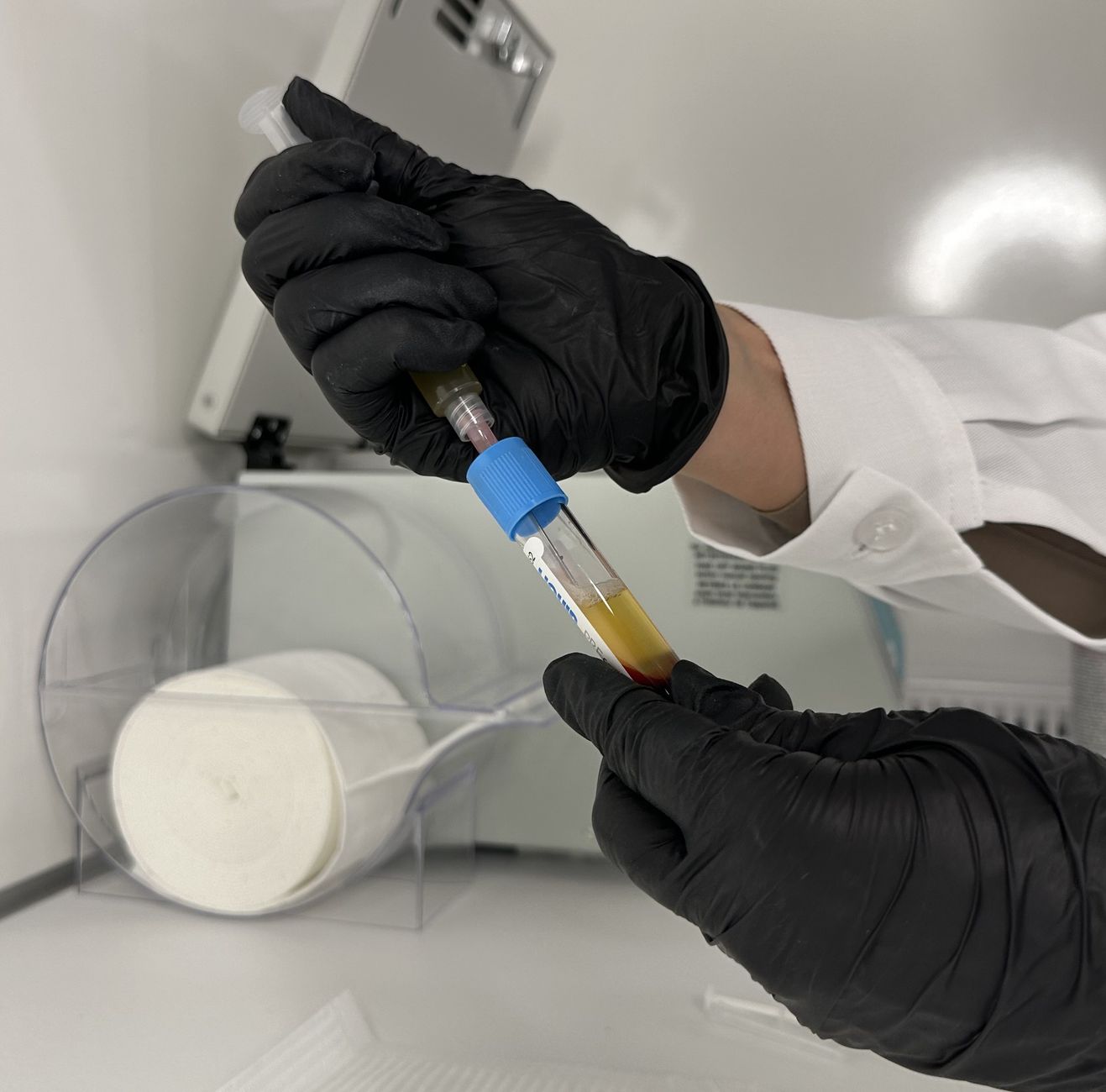 Technician collecting a lubricant fluid sample from equipment