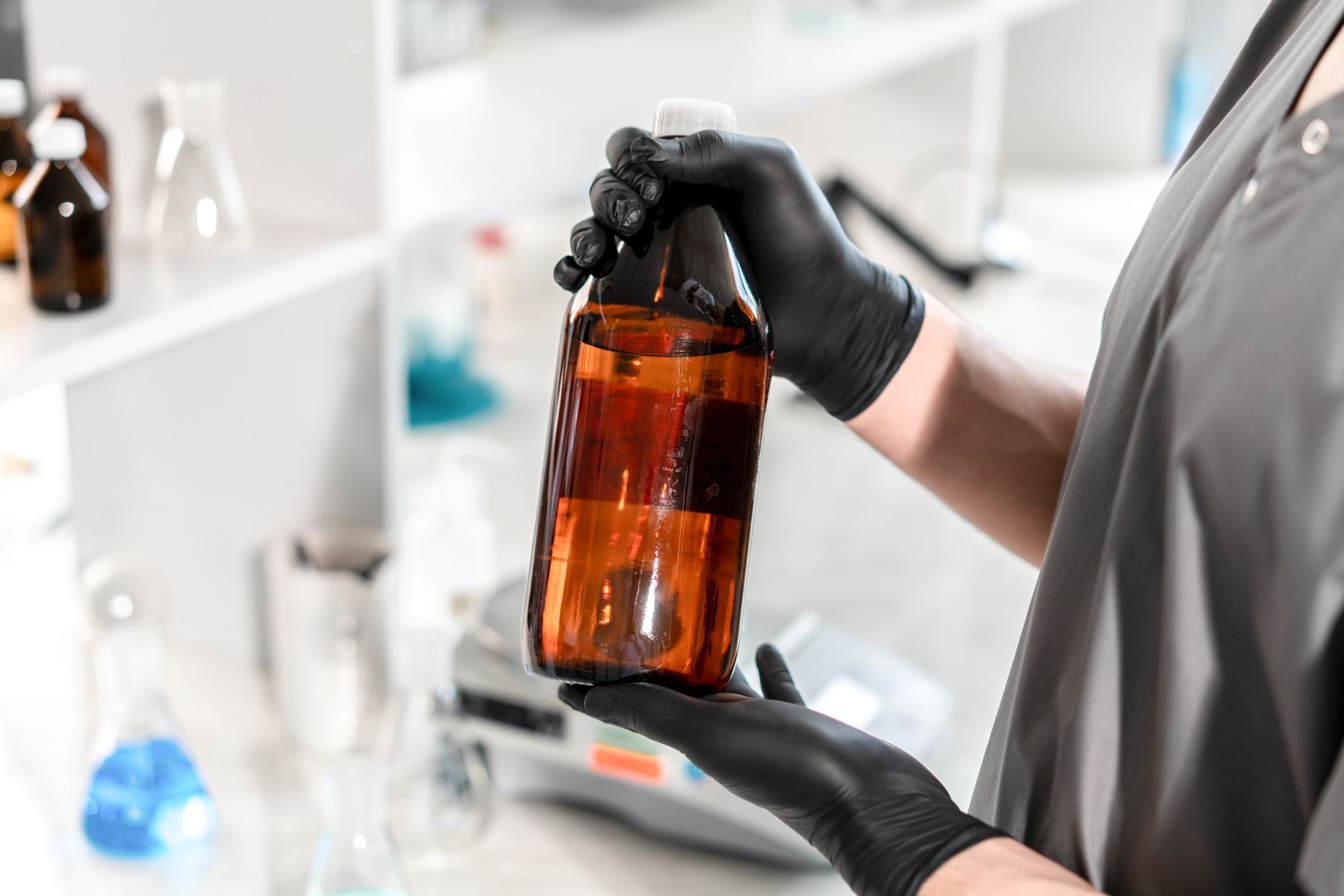 Technician collecting an oil sample from equipment