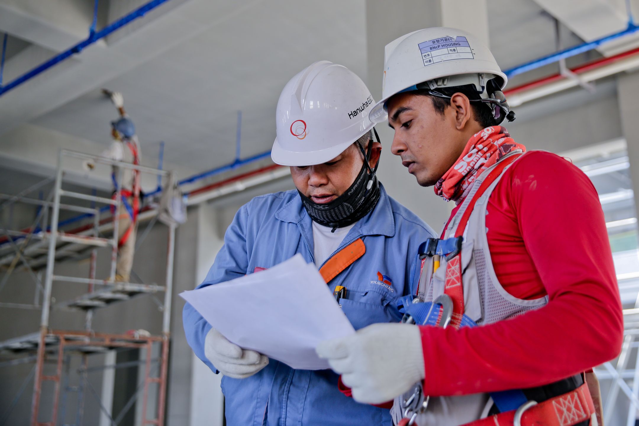 Two workers reviewing a document at a facility