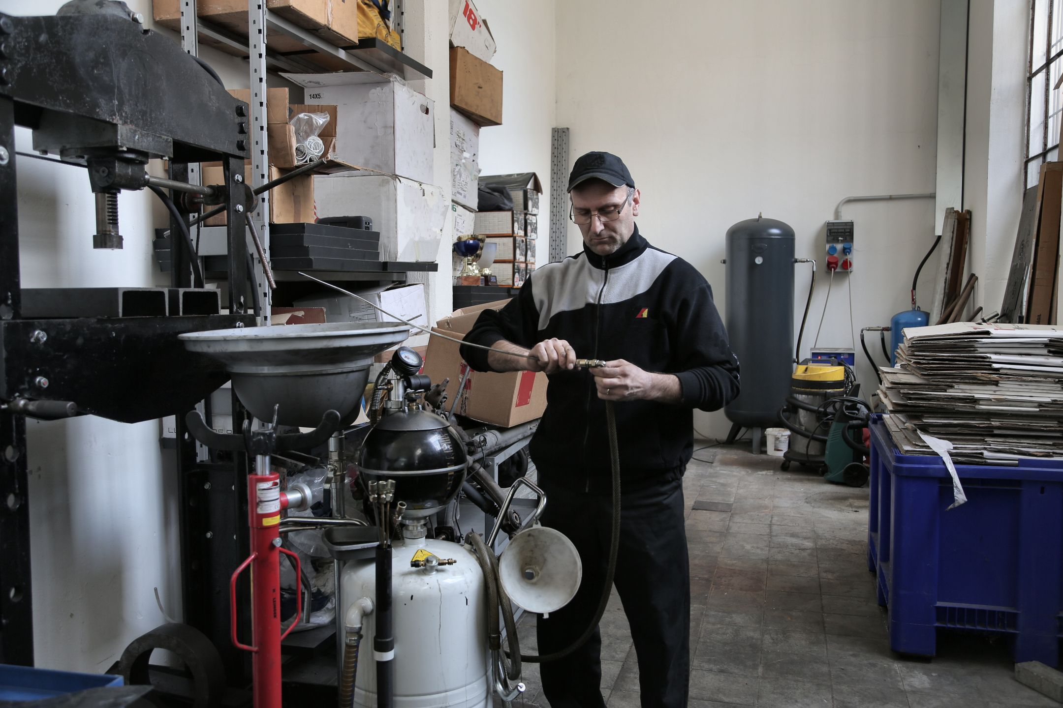 Mechanic fixing a compressor tube in a workshop
