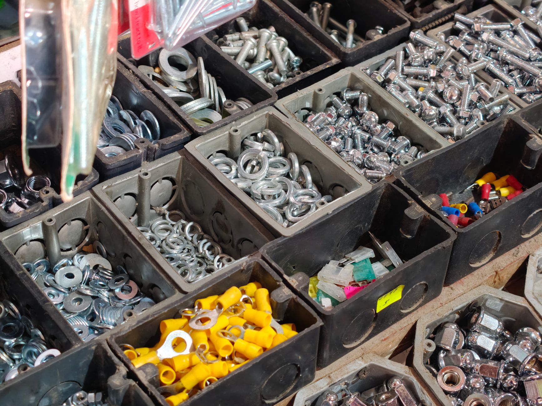Assembly worker using color-coded parts bins to prevent errors