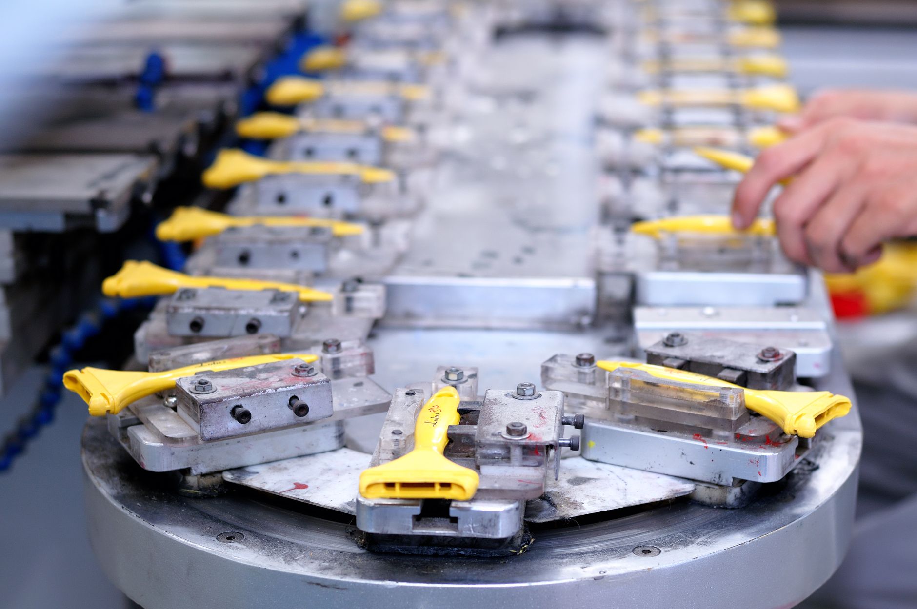 Worker using a verification jig on the assembly line