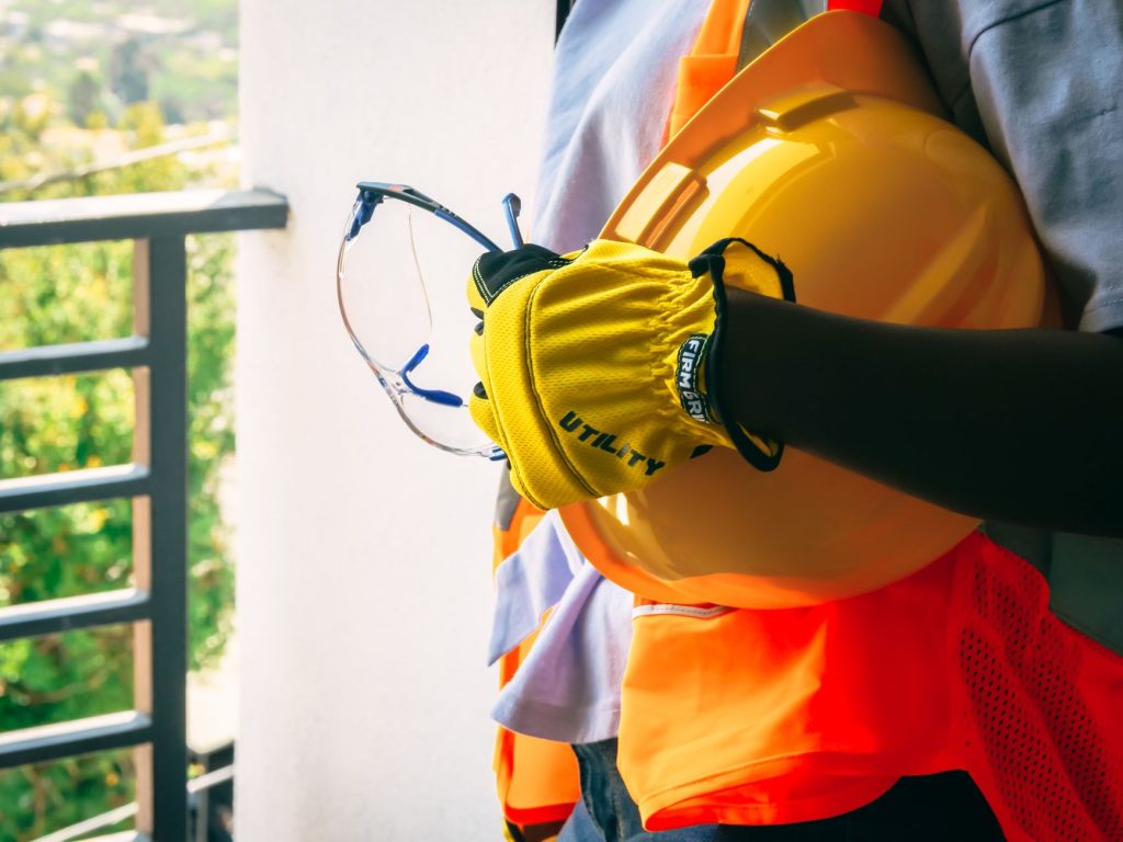 Worker wearing full personal protective equipment on a factory floor
