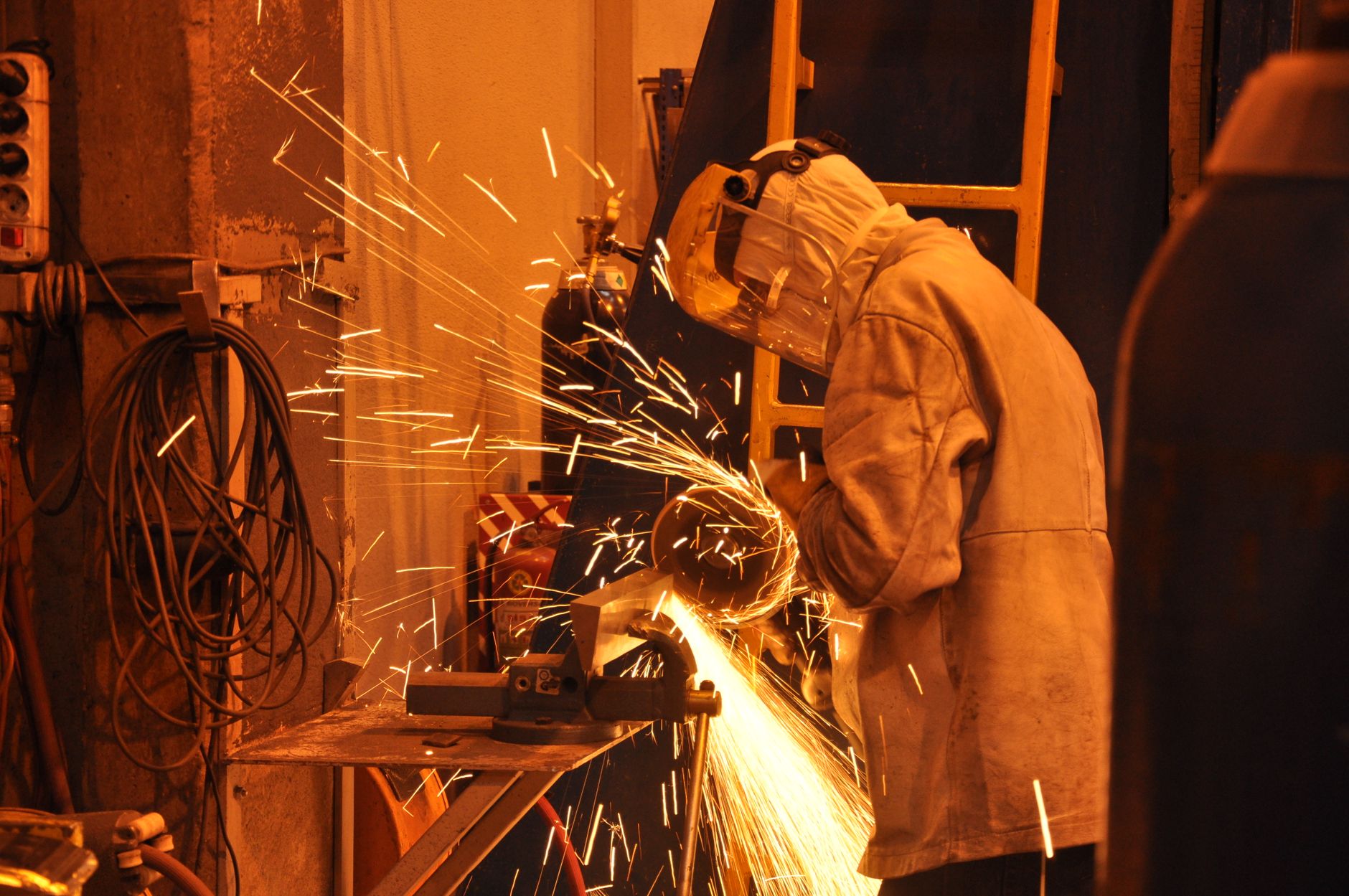 Technician wearing a face shield while grinding metal