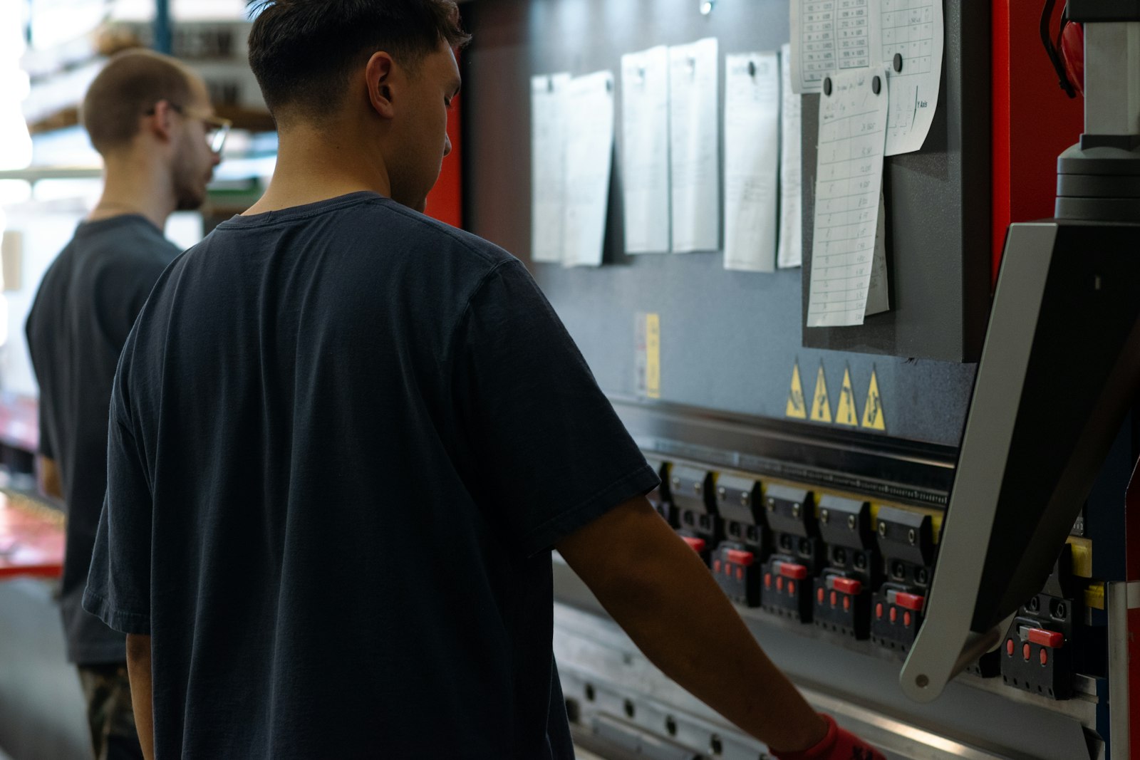 Press brake operator working from job tickets pinned to the machine, showing where problems actually start