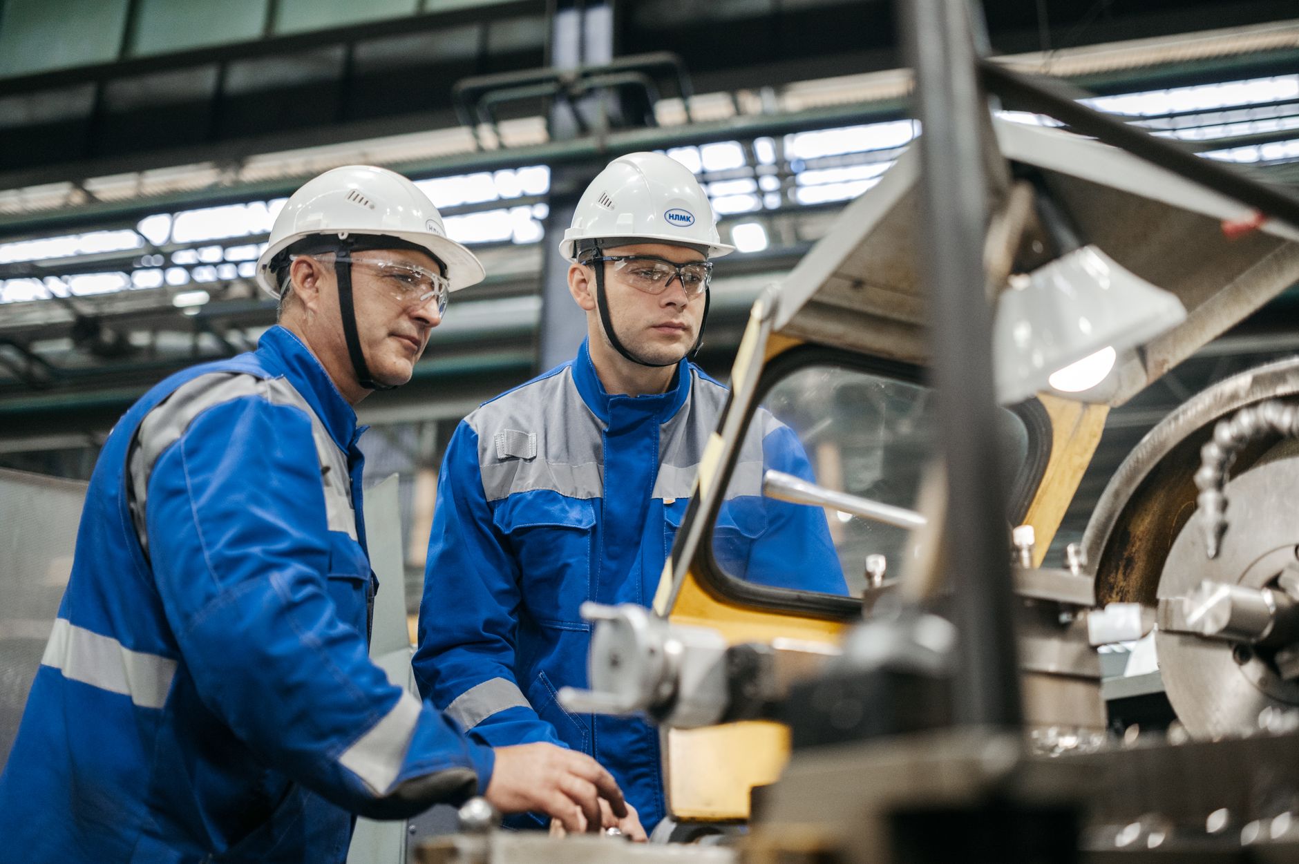 Assembly line workers operating production equipment