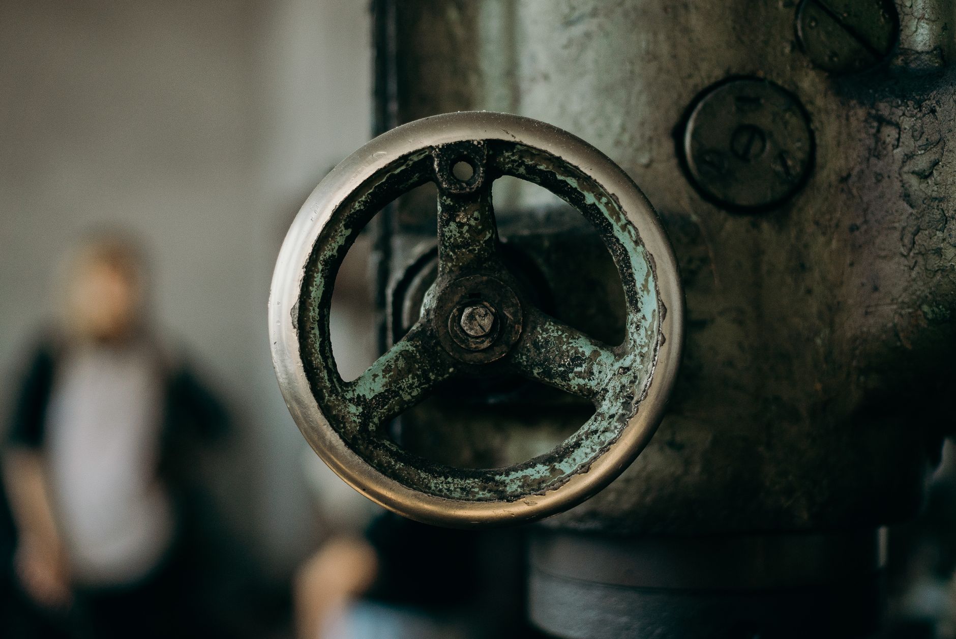 Engineer examining cavitation damage on a pump impeller